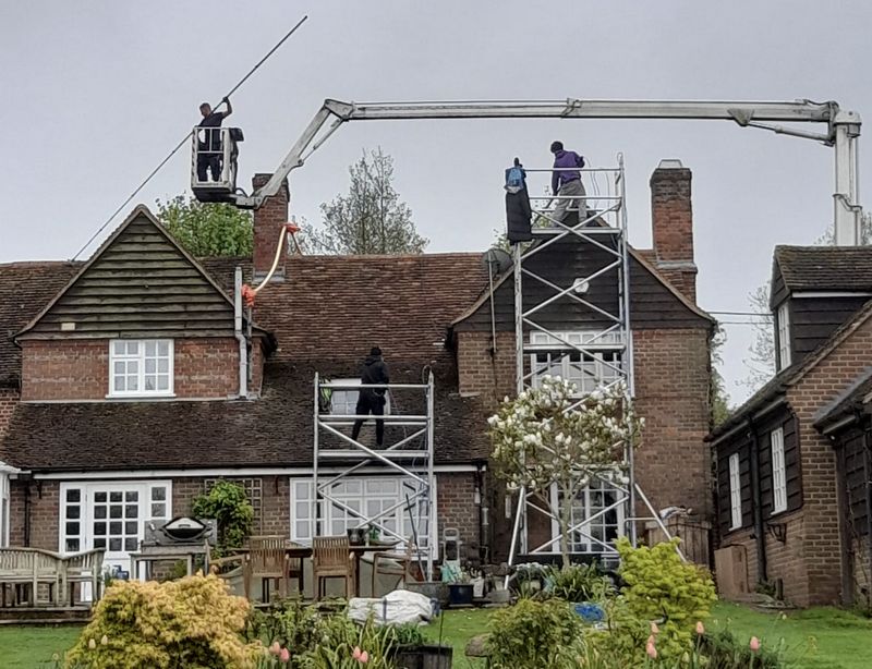 The Roof Moss Cleaners using cherry picker and scaffolding to clean roof safely and professionally in Luton, Bedfordshire